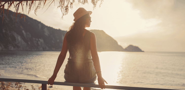 person sitting looking out on a body of water